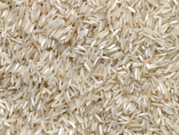 White Rice Grains On Brown Wooden Table